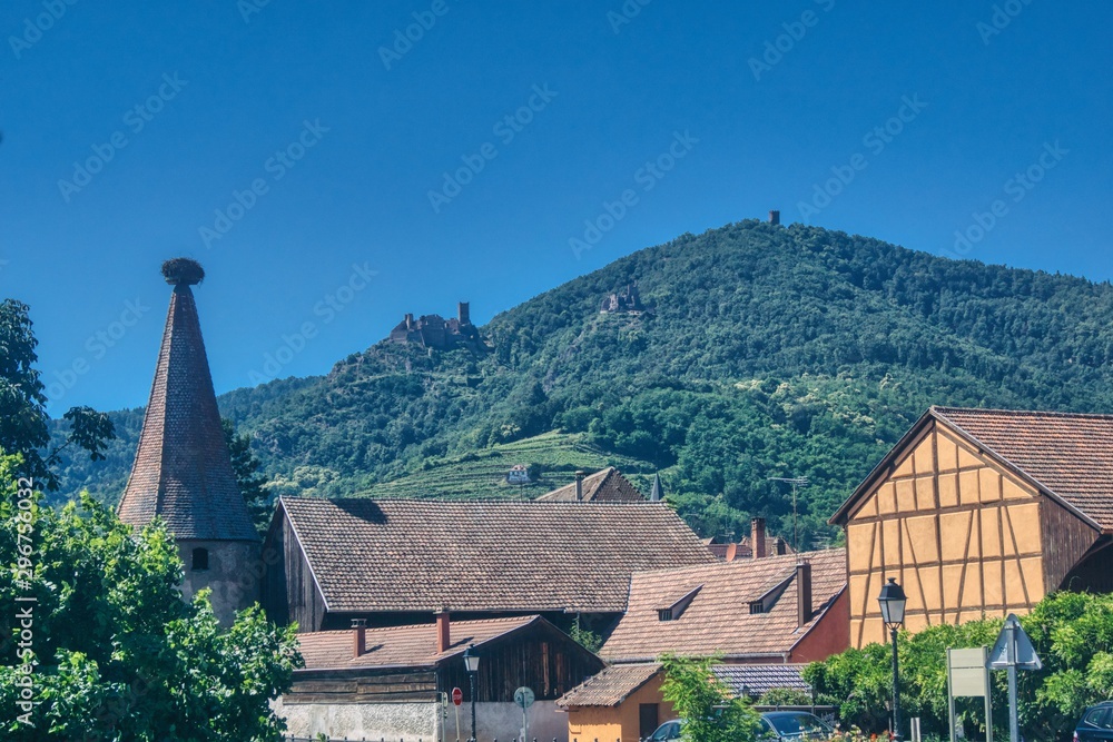 panorama of the Alsatian town of Ribeauville with a view of the stork tower and three castles on the hills