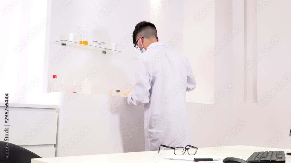 Pharmaceutical lab employee analyzes chemicals Pharmaceutical lab employee analyzes chemicals