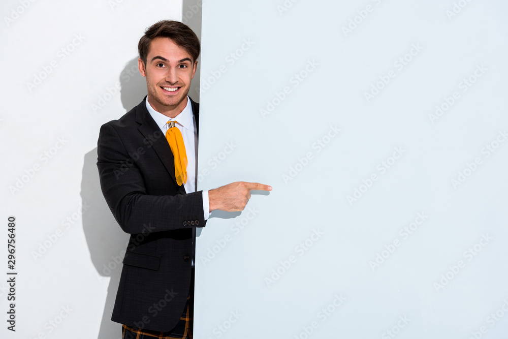 happy man in formal wear pointing with finger on white happy man in formal wear pointing with finger on white