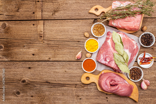 Assorted various fresh pork cuts. Raw meat with spices. Tenderloin, shoulder blade, neck