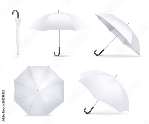 Realistic white umbrella open and folded lying in different angles photo