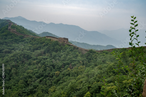 Great Wall of China with a green trees in a background. photo