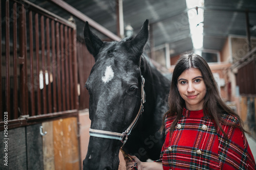 Girl with a horse at the stables