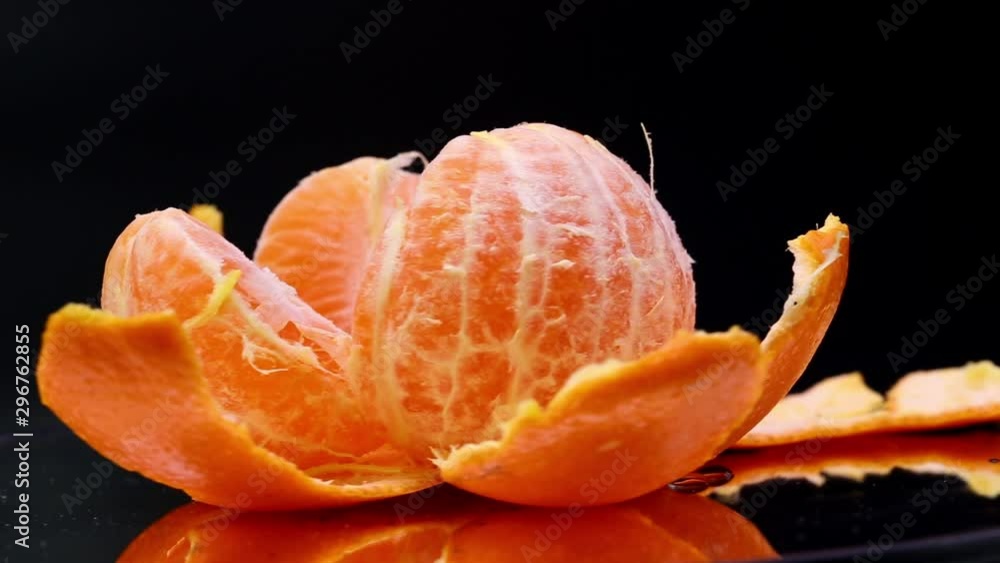 Close-up rotation of fresh orange rotating in black background Close-up rotation of fresh orange rotating in black background