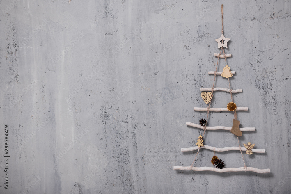 artificial christmas tree and copy space over grey concrete wall - obrazy, fototapety, plakaty 