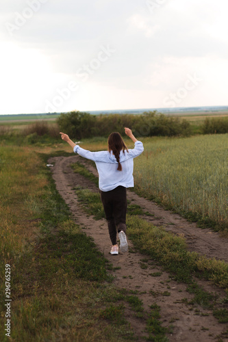 Happy Young Woman  in a linen shirt In A Field 