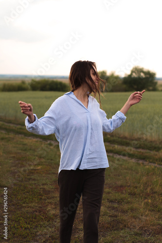 Happy Young Woman  in a linen shirt In A Field 