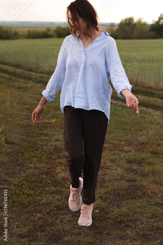 Happy Young Woman  in a linen shirt In A Field 