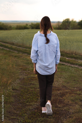 Happy Young Woman  in a linen shirt In A Field 