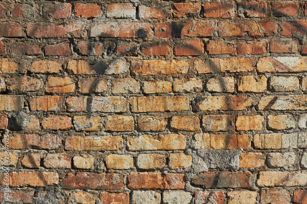 red brick wall texture, traces of black paint on the wall red brick wall texture, traces of black paint on the wall