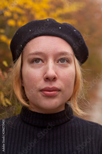 Blondy girl in black sweater and beret stands in the autumn in the park © Alexander Irbe