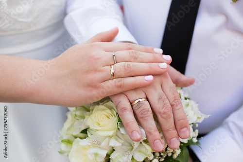 Bride and groom hands with wedding rings