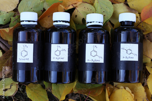 Aromatic hydrocarbons, petrochemicals in dark plastic bottles: toluene, o-xylene, m-xylene, p-xylene. Substances are used as solvents and as reagents in organic synthesis photo