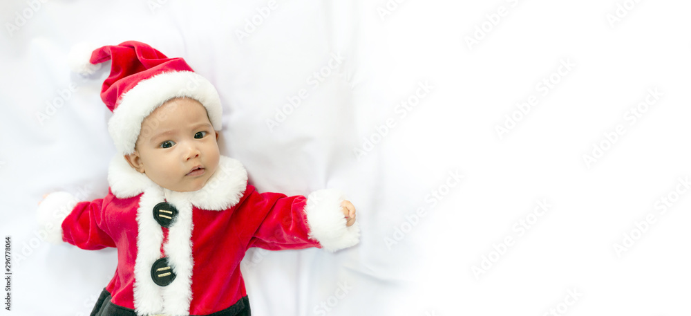 little baby wearing red Santa Claus costume sleep on white fur carpet. Concept of celebrates Christmas and New Year's holidays. with copy space for text. little baby wearing red Santa Claus costume sleep on white fur carpet. Concept of celebrates Christmas and New Year's holidays. with copy space for text.