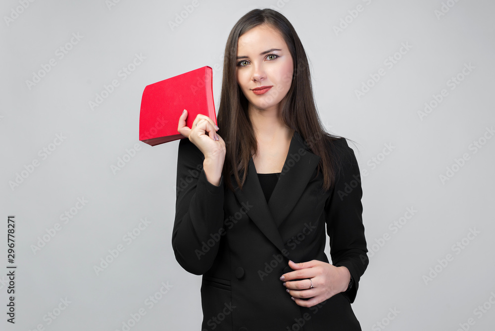 young brunette girl in business suit holding red Notepad, white background, dark straight hair, young brunette girl in business suit holding red Notepad, white background, dark straight hair,