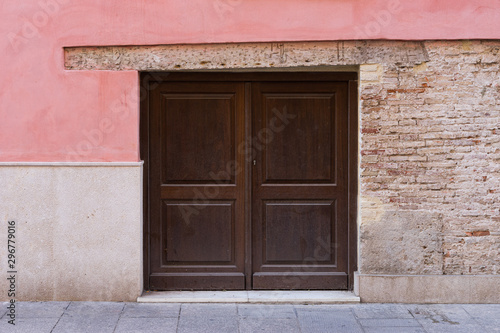 Small vintage door on a brick wall. Valencia, Spain