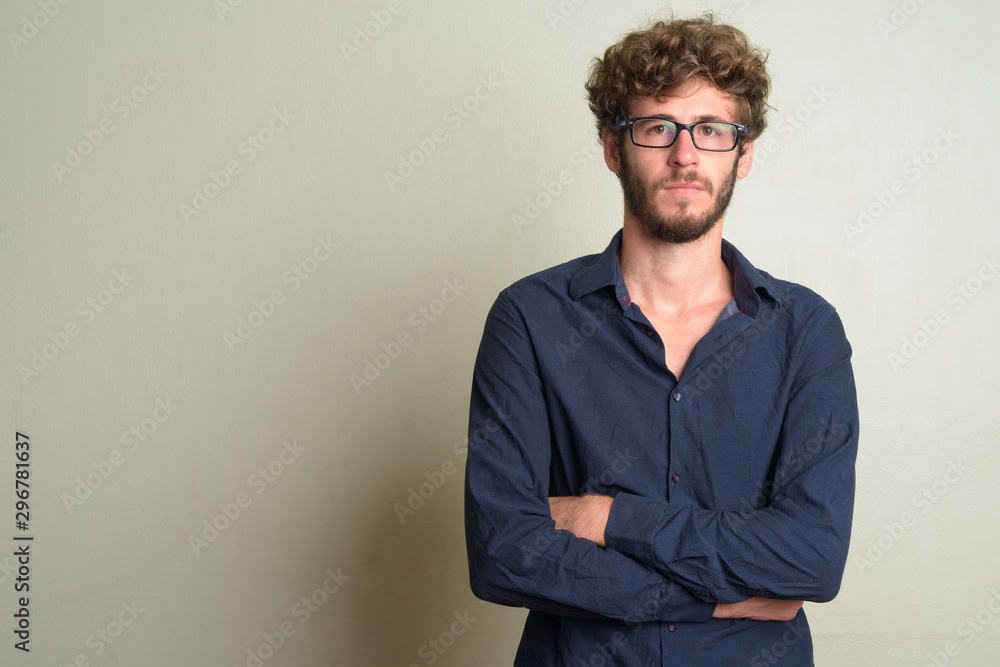 Young bearded businessman wearing eyeglasses with arms crossed Young bearded businessman wearing eyeglasses with arms crossed