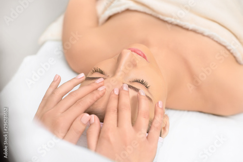 spa  resort  beauty and health concept - beautiful woman in spa salon getting face treatment