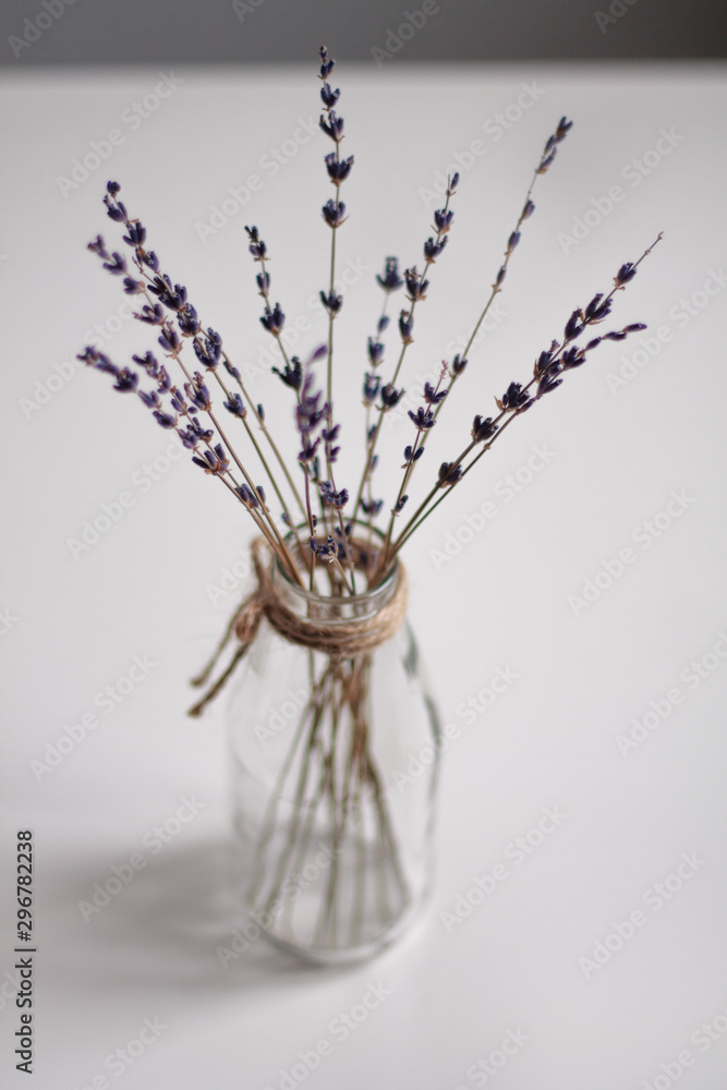 transparent vase in Scandinavian style with dried flowers purple on a light background vertical photo transparent vase in Scandinavian style with dried flowers purple on a light background vertical photo