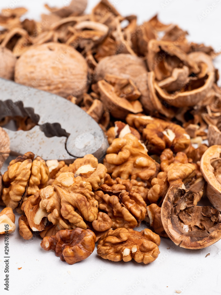 Chopped walnuts with kernels on a gray surface. Chopped walnuts with kernels on a gray surface.