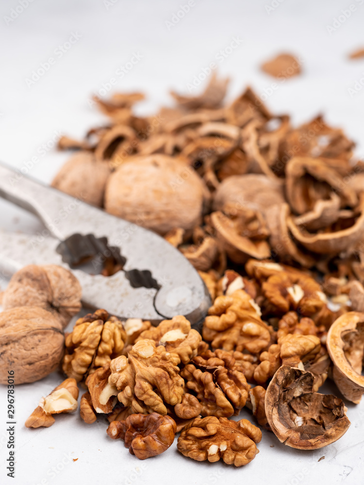 Chopped walnuts with kernels on a gray surface. Chopped walnuts with kernels on a gray surface.