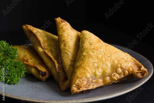 Samosas a spicy blend of vegetables or meat wrapped in a deep fried triangular pastry parcel a popular snack in the Middle East and South Asia