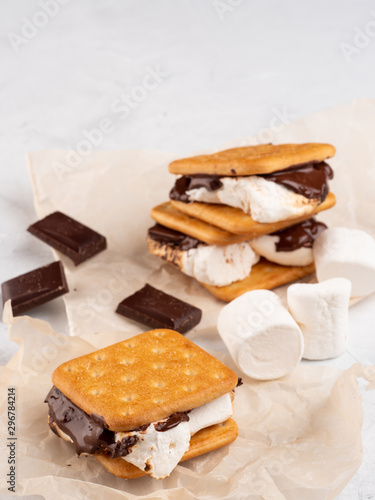 S'more on a gray surface with flowing chocolate.