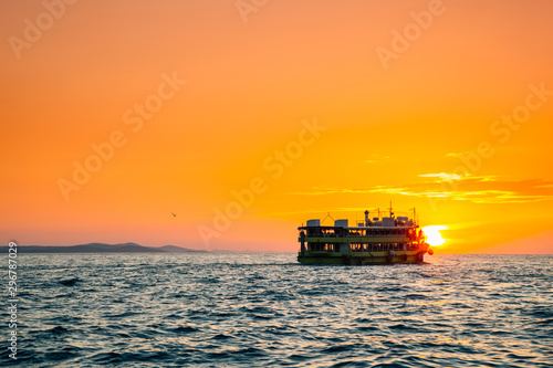 Orange sunset sea and ship in Zadar, Croatia