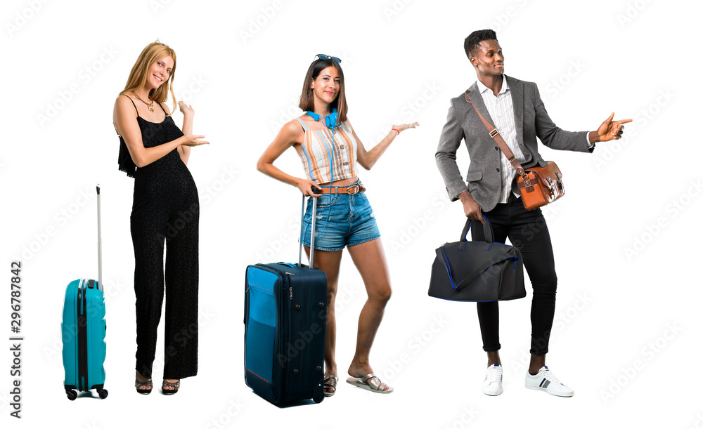 People traveling with suitcases pointing finger to the side and presenting a product People traveling with suitcases pointing finger to the side and presenting a product