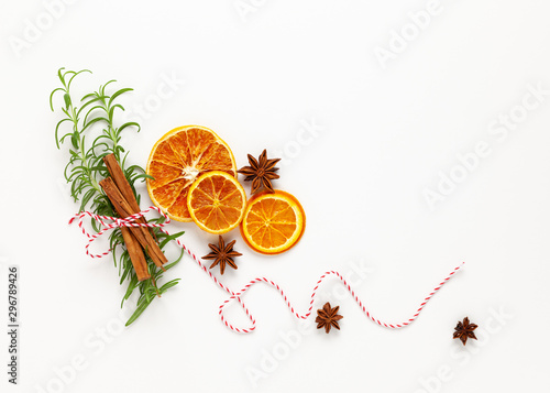 Fototapeta Naklejka Na Ścianę i Meble -   Christmas composition with dried oranges and spices on white background. Natural food ingredient for cooking or Christmas decor for home. Flat lay.