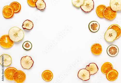 Fototapeta Naklejka Na Ścianę i Meble -  Christmas composition with dried oranges and apples slices on white background. Natural dry food ingredient for cooking or Christmas decor for home. Flat lay.