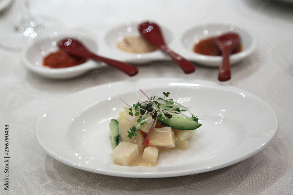 Chinese baked scallops with cucumber on white plate Chinese baked scallops with cucumber on white plate