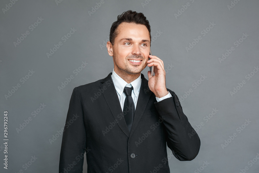 Businessman studio standing isolated on grey answering call looking aside confident Businessman studio standing isolated on grey answering call looking aside confident