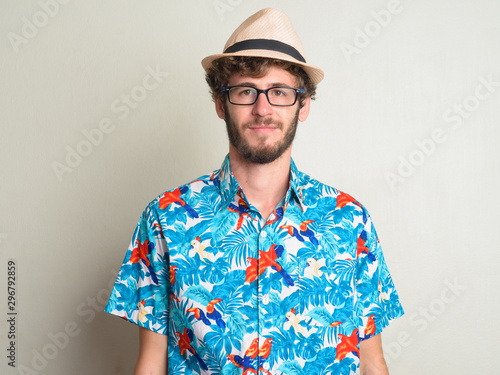 Face of young bearded tourist man with curly hair ready for vacation © Ranta Images