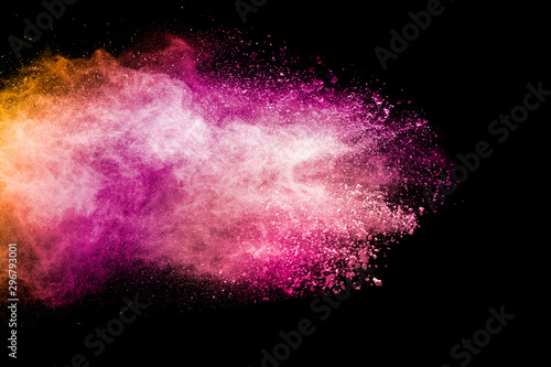 Abstract pink and orange powder explosion on black background. Freeze motion of pink orange dust splashing.