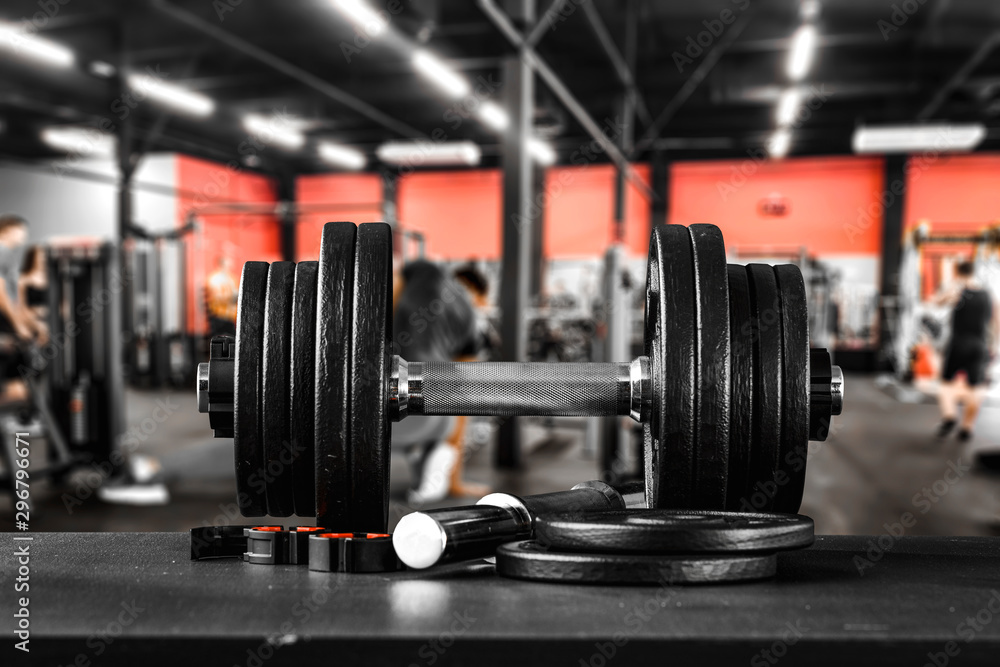 Dumbbell, barbell and workout in the gym. Running track and workout in the gym. Space with blurred gym background. Dumbbell, barbell and workout in the gym. Running track and workout in the gym. Space with blurred gym background.
