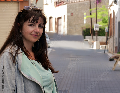 Portrait of a young attractive woman on a narrow street of a European city