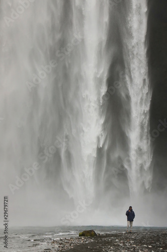 Tourist at Skogafoss Waterfall  famous natural landmark in Iceland  Europe