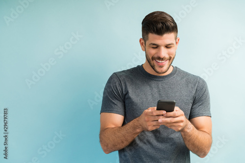 Attractive Hispanic Male Surfing On Mobile Phone