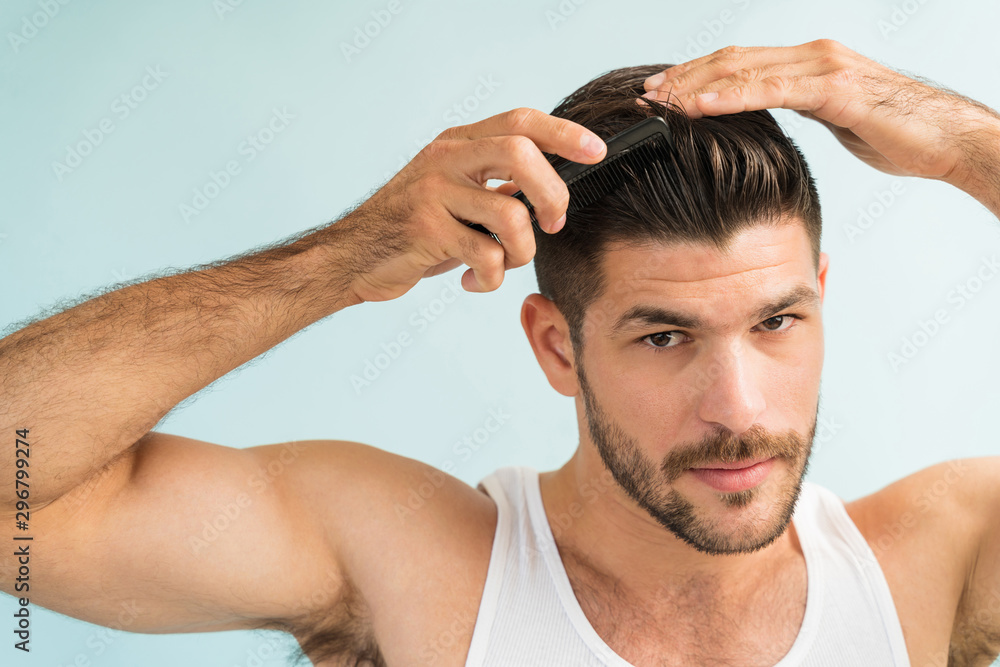 Portrait Of Attractive Latin Man Setting Hairstyle Portrait Of Attractive Latin Man Setting Hairstyle