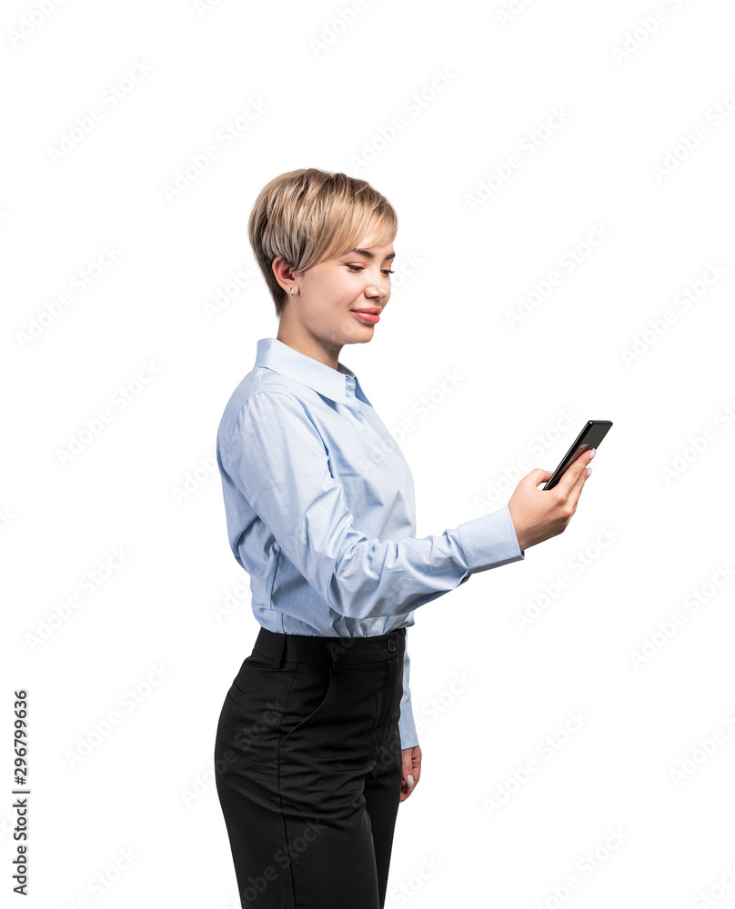 Smiling young businesswoman looking at smartphone Smiling young businesswoman looking at smartphone