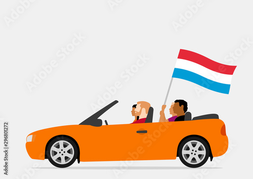 People in car with luxembourg flag
