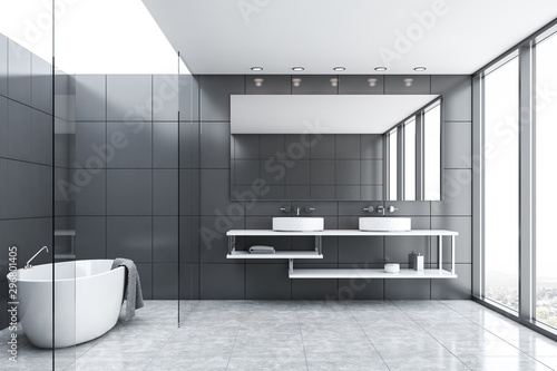 Gray tile and glass bathroom with tub and sink