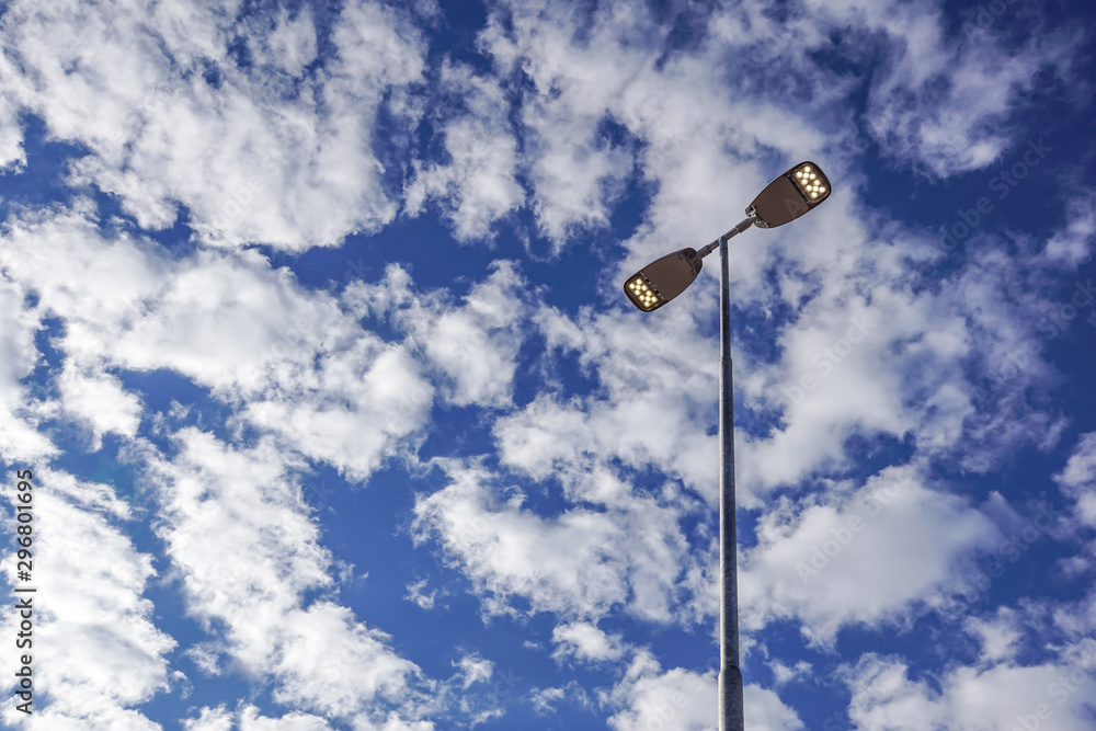 Three LED Street Lamps Affixed to an Iron Post Against a Deep Blue Sky