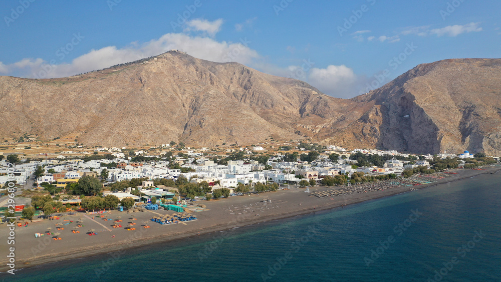 Aerial drone photo of famous volcanic beach and bay of Perissa village, Santorini island, Cyclades, Greece