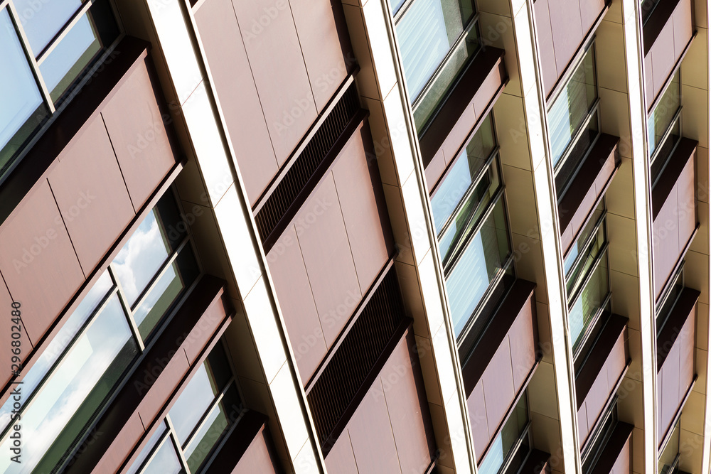 Bottom angular view of building with maroon walls and windows Bottom angular view of building with maroon walls and windows
