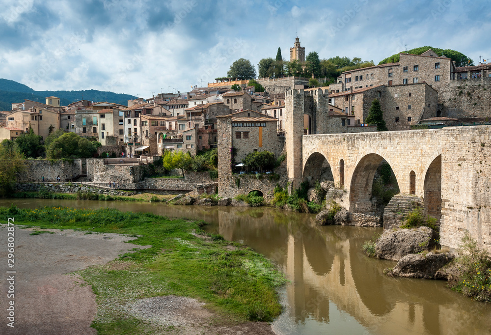 View of the medieval village and fortified bridge of Besalú in the region of La Garrotxa, Girona (Spain).