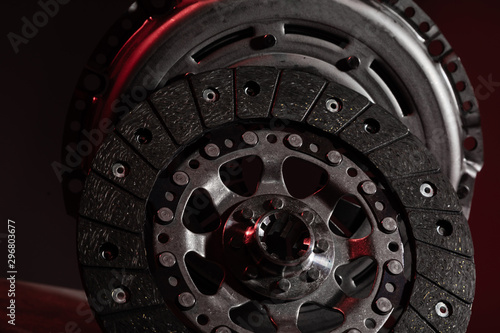 Two circle brake discs on dark red background. Disc brake rotors are metal discs that work together with the brake pads and calipers to slow the vehicle.
