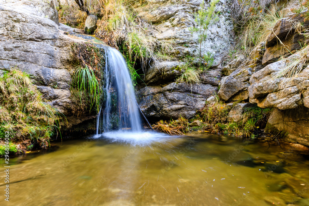 Small waterfall in a stream in the mountains of Madrid, right in La Pedriza
