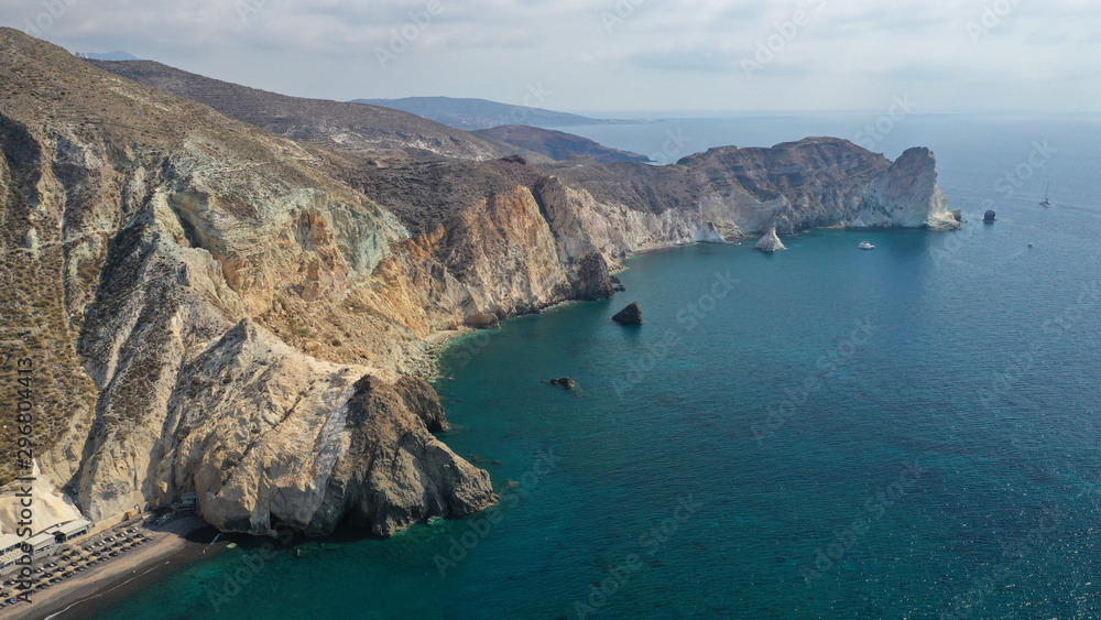 Aerial drone photo of iconic famous White beach with deep rocky and volcanic turquoise sea visited by sail boats, Santorini island, Cyclades, Greece Aerial drone photo of iconic famous White beach with deep rocky and volcanic turquoise sea visited by sail boats, Santorini island, Cyclades, Greece